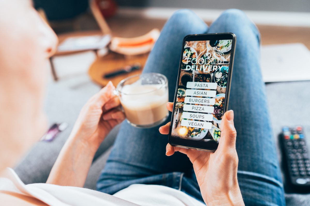 Woman ordering food online on her electronic device