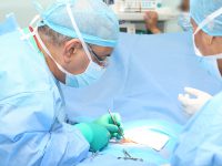 Doctor making a suture in operation room