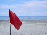 Red flag with the sea, Signal warning on the beach.