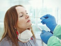 Medic taking sample from patients nose for coronavirus testing