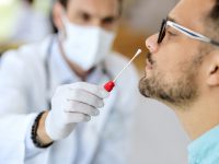 Close-up of young man getting PCR test at doctor's office during coronavirus epidemic.