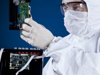 Engineer examining circuit board.