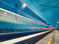 Light trail of the express train in the railway station at the night.